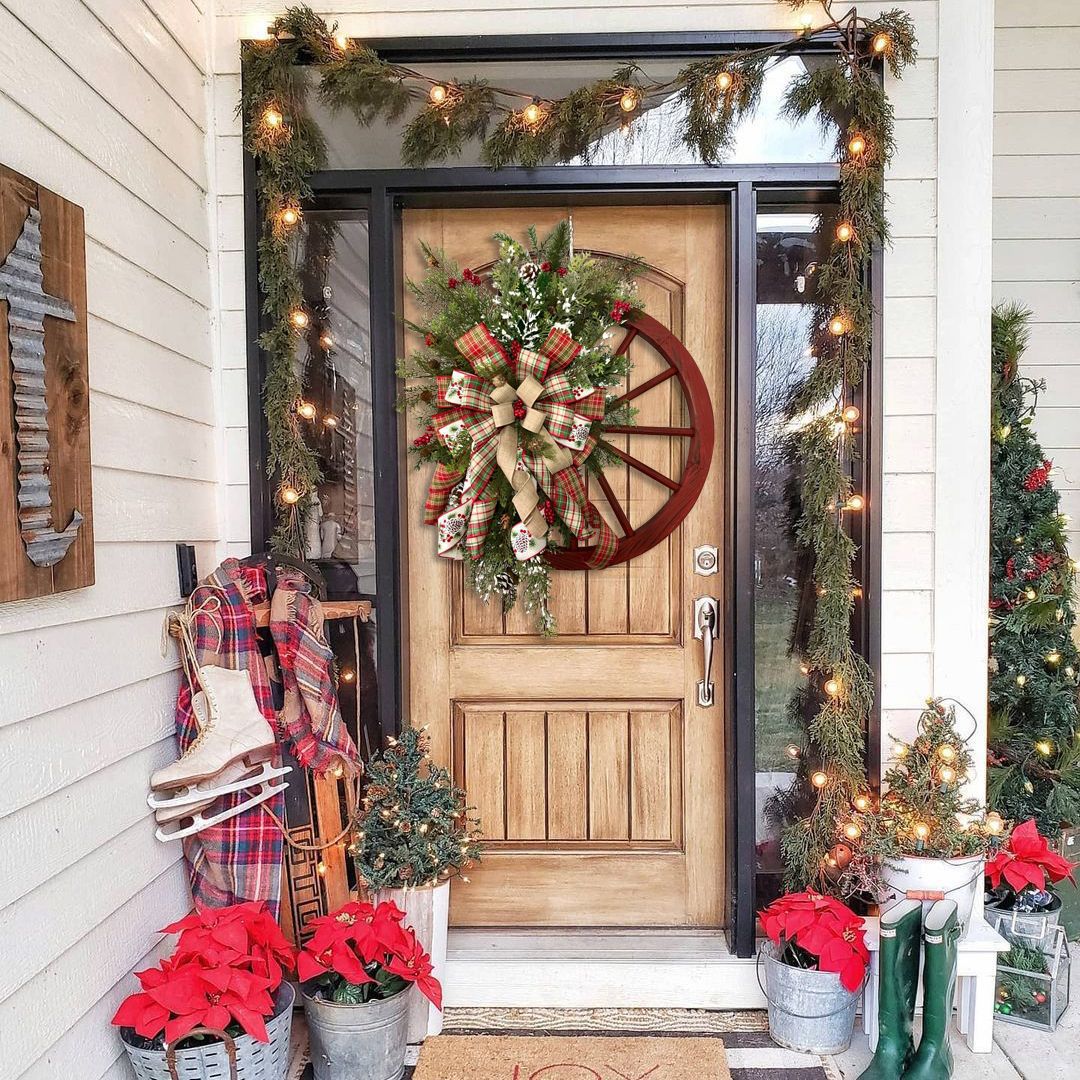 Charming Christmas red wooden wheel wreath on a rustic front door, adorned with festive decorations and greenery.