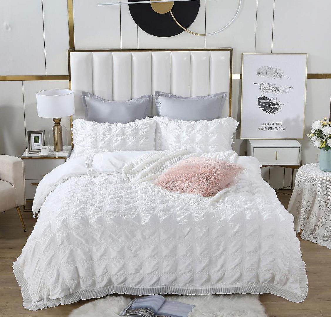 Elegant white ruffles textured jacquard duvet cover set on a stylish bed with decorative pillows and soft blankets.