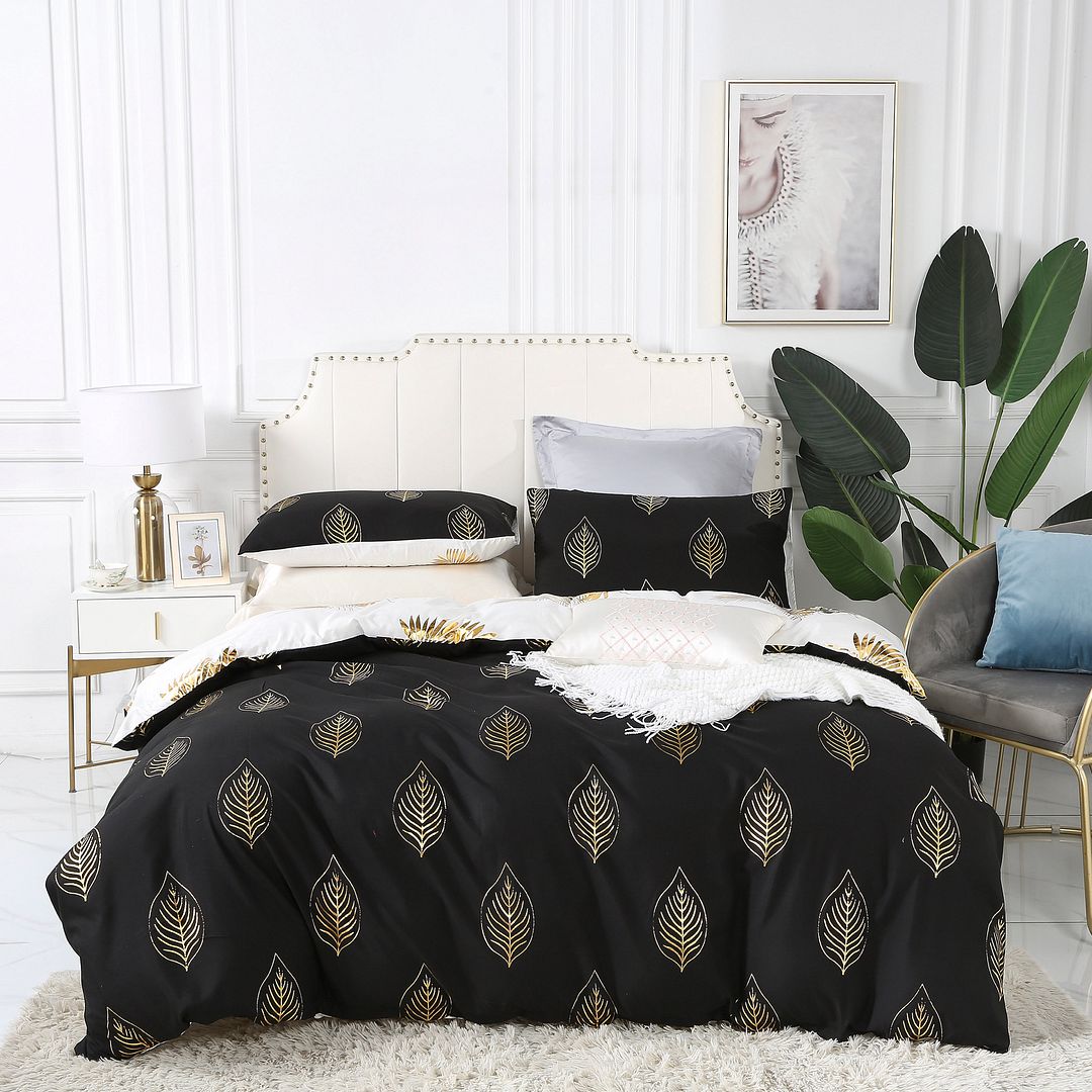 Reversible king size quilt cover set featuring elegant leaf design on a black background, perfect for stylish bedroom decor.