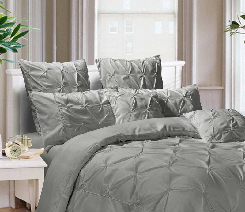 Diamond Pintuck Grey European Pillowcases 2-Pack on a bed, showcasing elegant texture and softness.