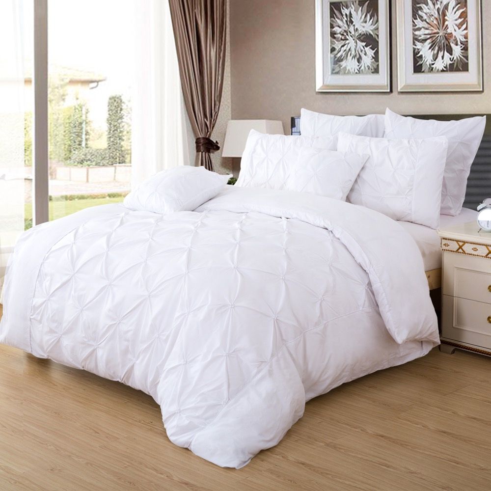 Elegant white quilt cover set with diamond pintuck design, enhancing bedroom decor and comfort. Perfect for super king size beds.