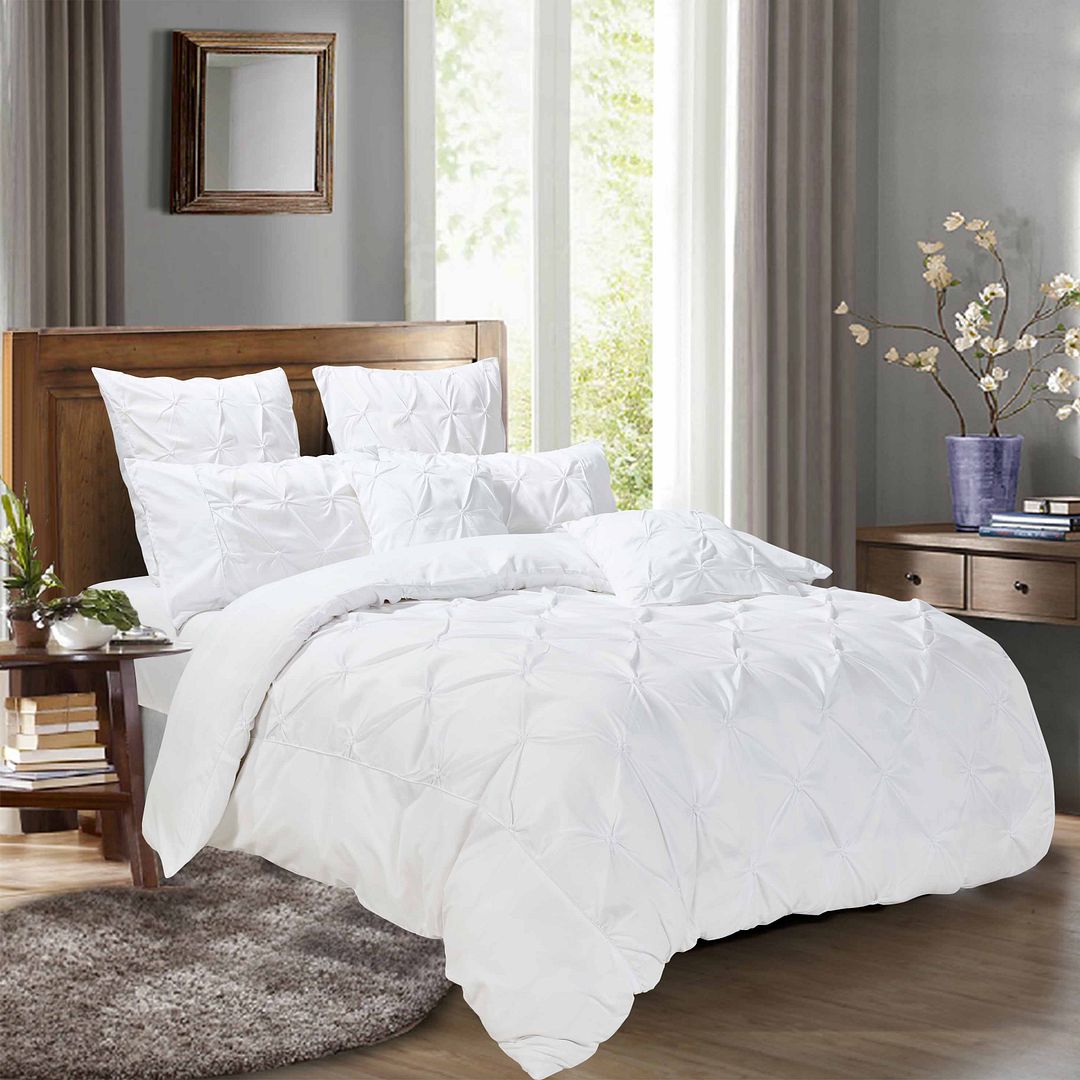 Diamond pintuck white duvet quilt cover set in a stylish bedroom with matching pillowcases and elegant decor.