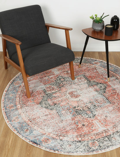 Vintage Crown Cezanne terracotta round rug paired with a modern chair and table in a stylish living space.