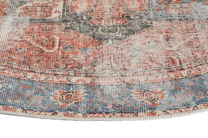 Vintage Crown Cezanne terracotta round rug close-up, showcasing intricate patterns and distressed texture in soft colors.