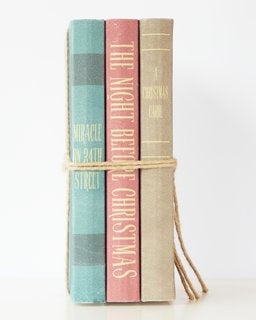 Charming Christmas book stack featuring classic holiday tales, perfect for festive decor and holiday spirit.