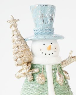 Adorable snowman with blue hat and mini Christmas tree, perfect for festive table decorations or holiday displays.