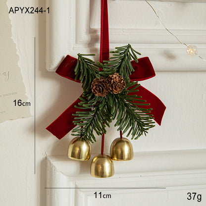 Christmas door ornament with pinecones, golden bells, and red ribbon, perfect for holiday decorations.