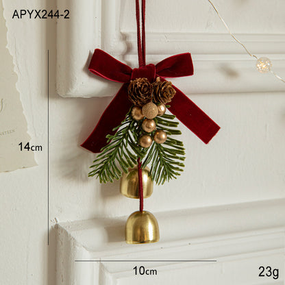 Christmas door ornament featuring red velvet bow, pinecones, golden bells, and berries, perfect for festive decorations.