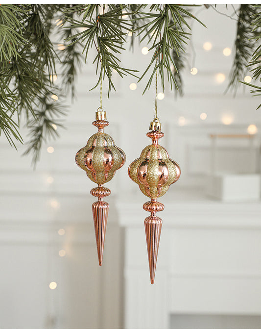 Elegant gold and rose gold Christmas ornaments hanging on a festive tree, perfect for xmas tree decorations.