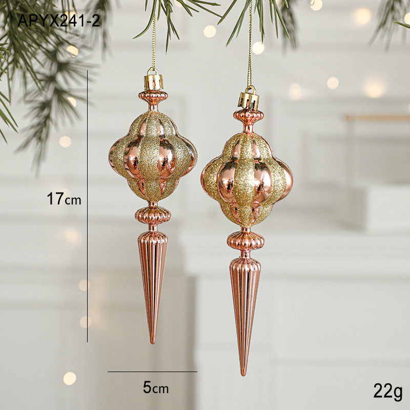 Elegant rose gold and gold Christmas ornaments hanging as tree decorations, ideal for enhancing your Xmas tree decor.