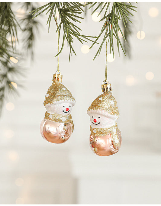 Set of 2 gold and rose gold snowman Christmas ornaments hanging on a tree, perfect for festive decorations.