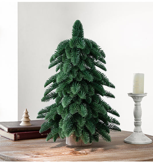 55cm artificial mini Christmas tree on a wooden table, perfect for festive indoor holiday decoration.