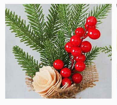 Mini Christmas pine tree decoration with red berries and burlap base, perfect for festive table decor.