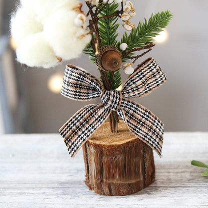 Mini rustic Christmas tree with cotton and plaid bow, perfect for festive xmas table decorations.