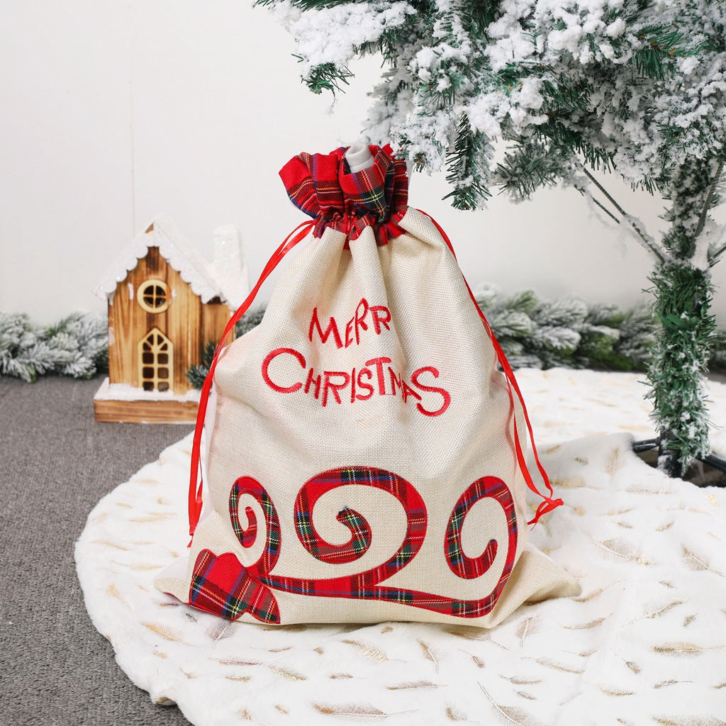 Large Merry Christmas drawstring gift bag with plaid accents, perfect for holiday presents and festive celebrations.