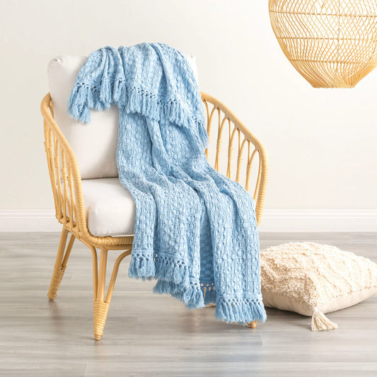 Alysian Washed Cotton Textured Sky Throw draped over a stylish chair, showcasing its plush texture and crochet fringe detail.