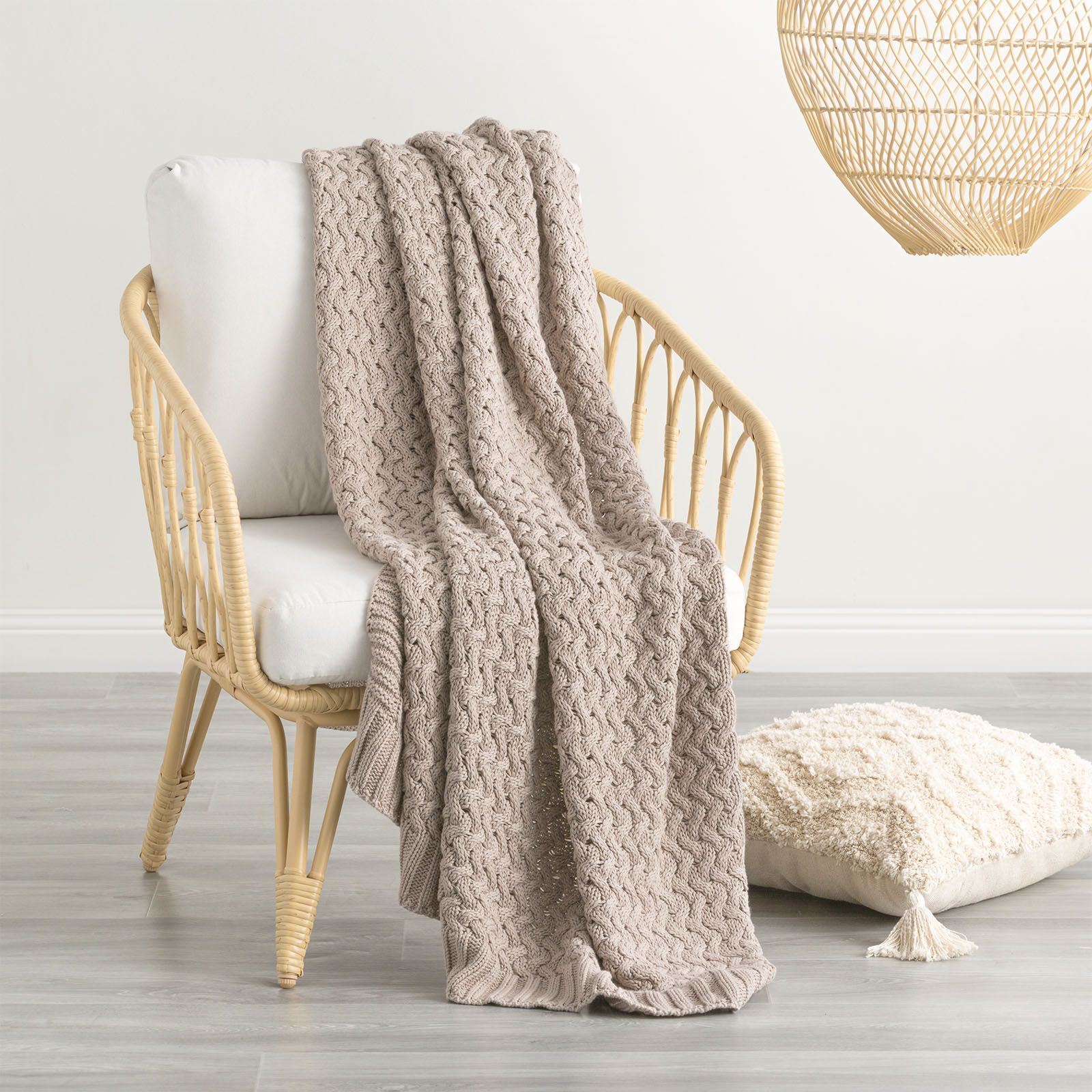 Lenni 100% cotton camel throw blanket by Renee Taylor, featuring chunky knit design on chair for cozy home decor.